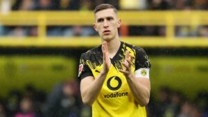 Nico Schlotterbeck im Trikot von Borussia Dortmund klatscht auf dem Rasen in die Hände