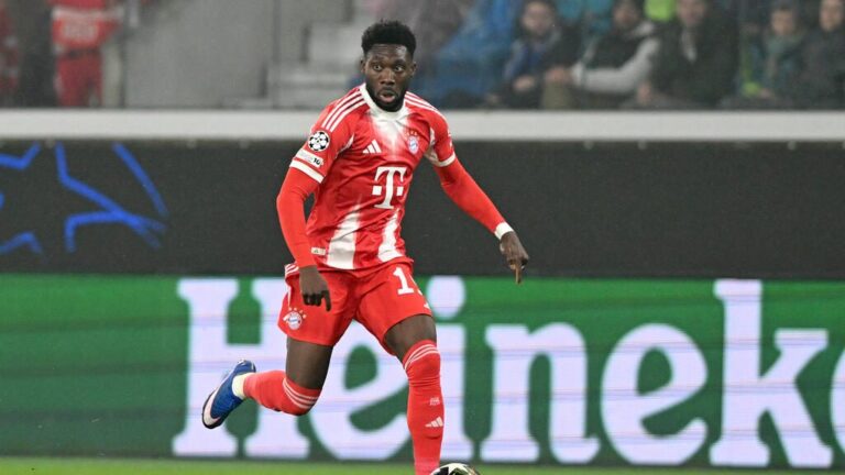 Alphonso Davies im Trikot des FC Bayern München blickt konzentriert auf das Spielfeld