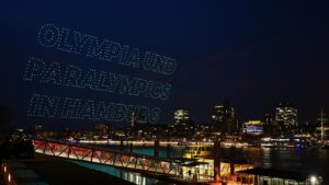 Symbolbild zur deutschen Olympia-Bewerbung mit olympischen Ringen und der Skyline einer deutschen Großstadt