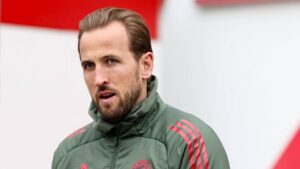 Harry Kane im Trikot des FC Bayern München blickt nachdenklich auf den Rasen.