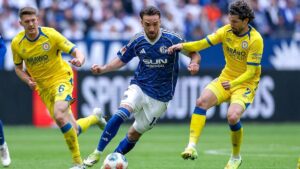 Jubelnde Spieler des FC Schalke 04 und von Eintracht Braunschweig auf dem Rasen nach dem Schlusspfiff