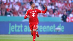 Michael Olise jubelt im Trikot des FC Bayern München auf dem Spielfeld