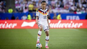 Jamal Musiala im Trikot des FC Bayern München blickt konzentriert auf dem Spielfeld