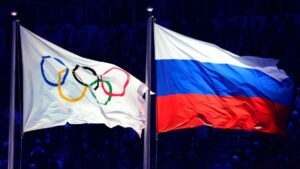 Die Olympischen Ringe vor einem dunklen Hintergrund als Symbol für die umstrittene Politik des IOC