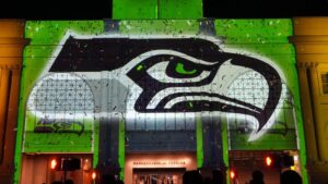 Helm und Logo der Seattle Seahawks auf dem Spielfeld vor voll besetzten Zuschauerrängen