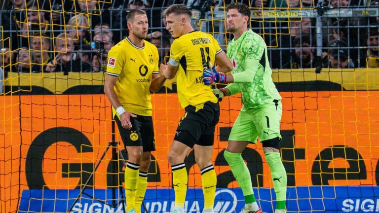 BVB-Torhüter Gregor Kobel klatscht im gelben Trikot auf dem Spielfeld in die Hände