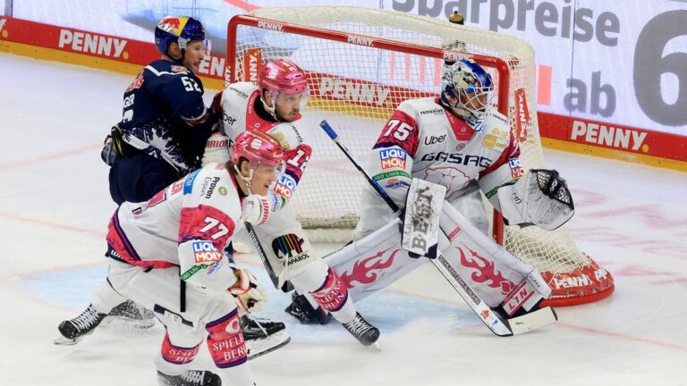 Spieler der Eisbären Berlin und des EHC Red Bull München im Zweikampf auf dem Eis