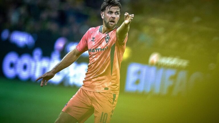 Niclas Füllkrug im Trikot von Werder Bremen schaut erschöpft auf den Rasen